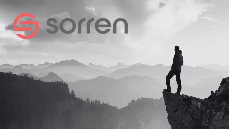 A silhouetted person standing on a cliff with mountains in the background, in black and white, with Sorren logo.