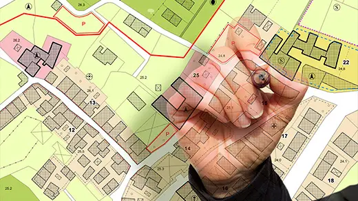 A hand holding a pen marks locations on a detailed map of a neighborhood. Opportunity Zones under OBBA.